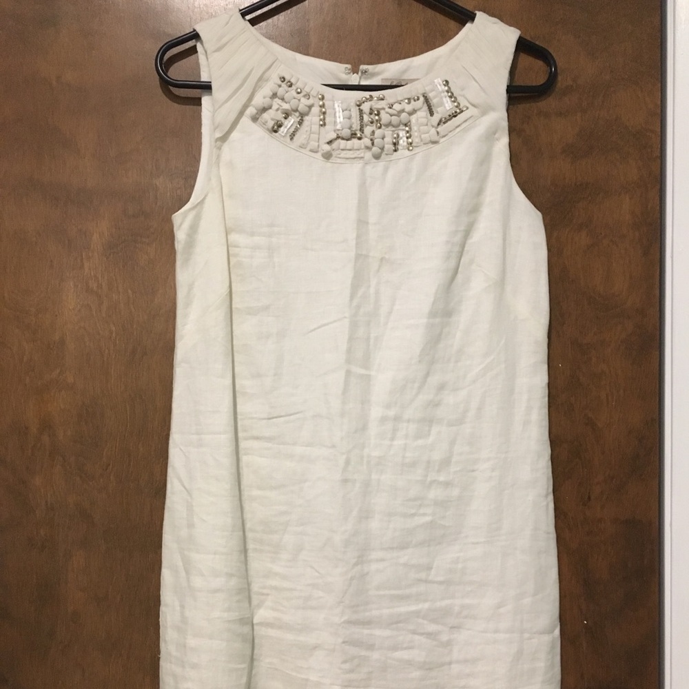 White linen dress with gem decorated neckline